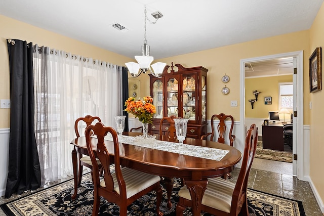 dining area with an inviting chandelier