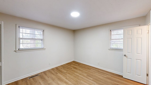 spare room featuring light hardwood / wood-style flooring