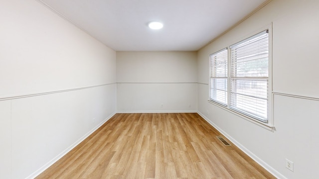 empty room with light hardwood / wood-style floors