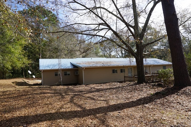 back of house with a deck