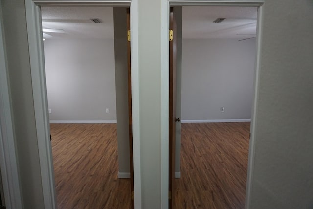 hallway with dark hardwood / wood-style floors