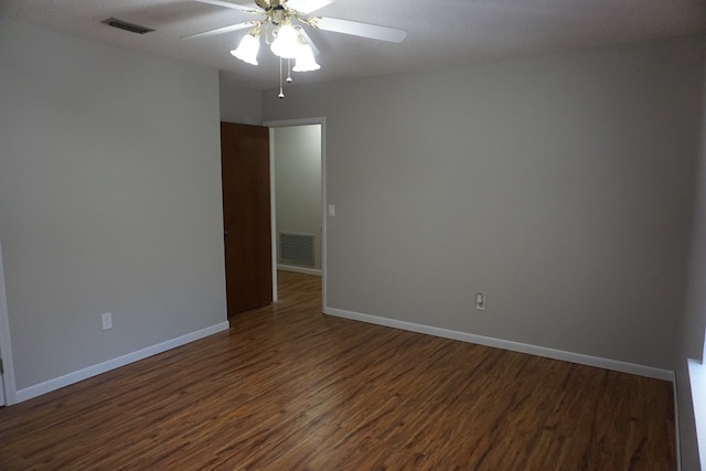 unfurnished room with dark wood-type flooring and ceiling fan