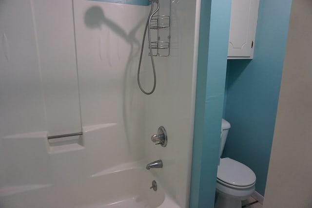 bathroom with tub / shower combination and toilet