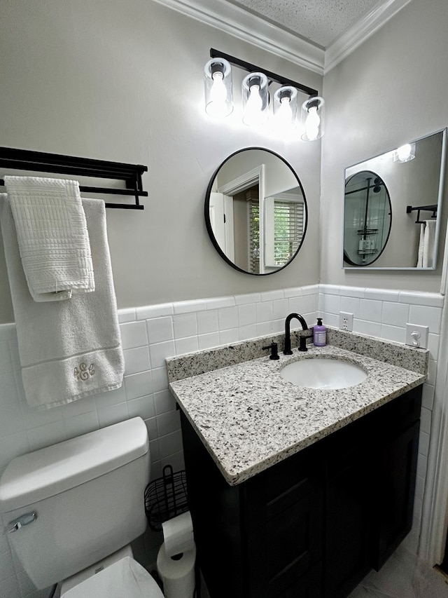 1002 Monterey Ct, Dothan, AL 36303 - bathroom with tile walls, ornamental molding, vanity, toilet, and wainscoting
