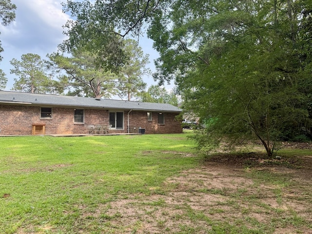 1002 Monterey Ct, Dothan, AL 36303 - back of property with a yard, brick siding, and central AC unit