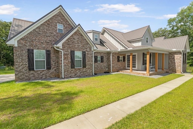 1913 W Malvern Hwy, Slocomb, AL 36375 - view of front of home with a front lawn, board and batten siding, brick siding, metal roof, and a standing seam roof