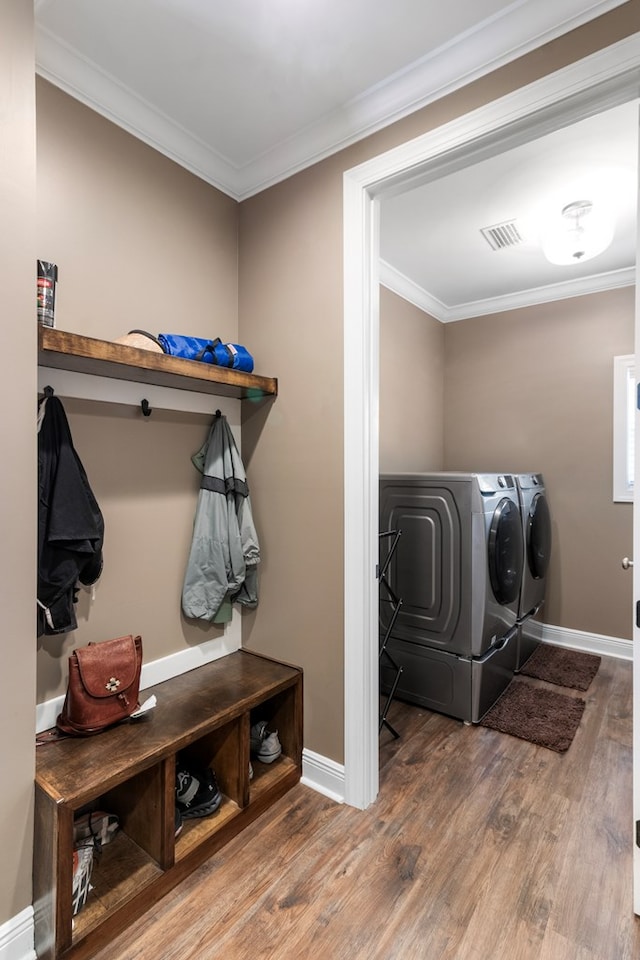 1913 W Malvern Hwy, Slocomb, AL 36375 - laundry area featuring separate washer and dryer, wood finished floors, crown molding, and baseboards