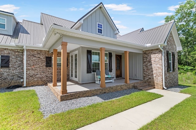 1913 W Malvern Hwy, Slocomb, AL 36375 - rear view of house featuring board and batten siding, brick siding, metal roof, and covered porch
