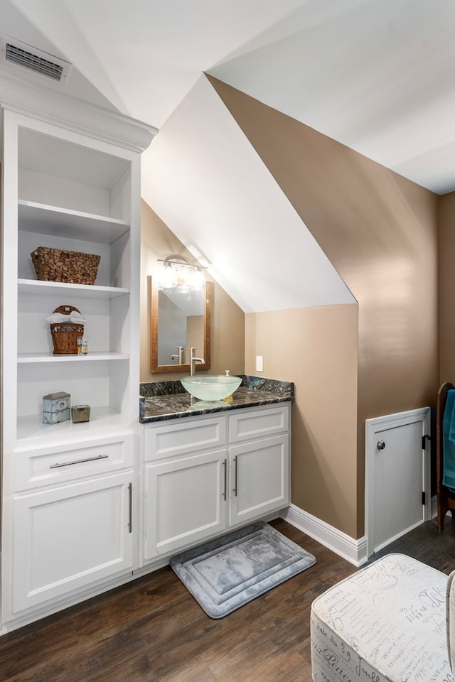 1913 W Malvern Hwy, Slocomb, AL 36375 - bathroom featuring wood finished floors, vanity, and baseboards