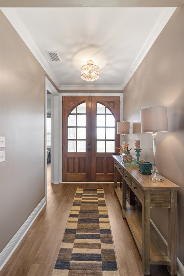 1913 W Malvern Hwy, Slocomb, AL 36375 - foyer with dark wood-style flooring, a chandelier, french doors, crown molding, and baseboards