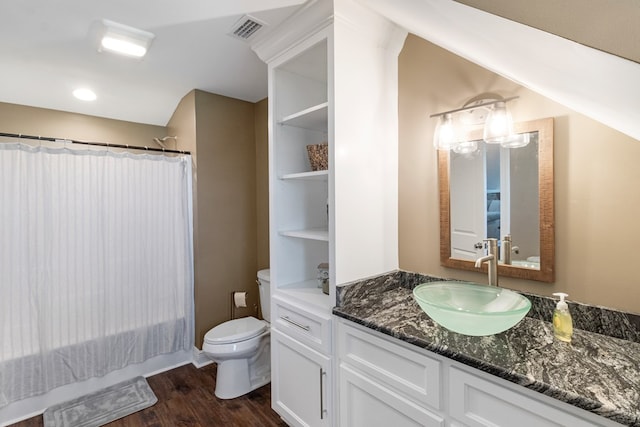 1913 W Malvern Hwy, Slocomb, AL 36375 - bathroom featuring vanity, wood finished floors, toilet, and shower / tub combo with curtain