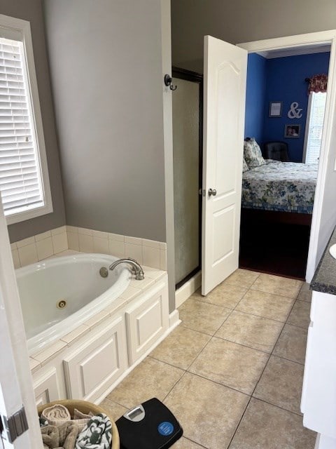 109 Talquin Ct, Dothan, AL 36301 - ensuite bathroom featuring connected bathroom, a stall shower, tile patterned flooring, and a whirlpool tub
