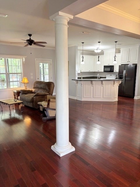 109 Talquin Ct, Dothan, AL 36301 - living room with a ceiling fan, dark wood finished floors, crown molding, and ornate columns