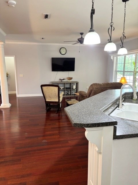 109 Talquin Ct, Dothan, AL 36301 - kitchen with visible vents, crown molding, dark countertops, a ceiling fan, and dark wood finished floors