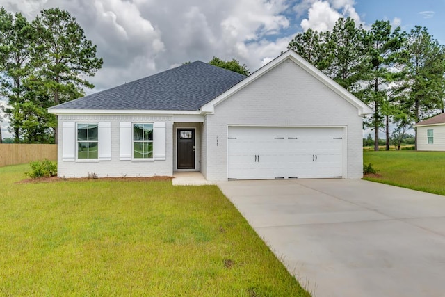 view of front of property featuring a front yard and a garage