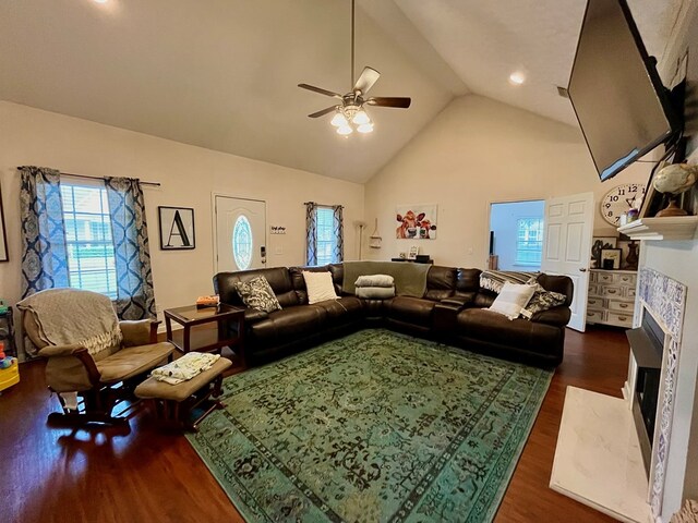 living room featuring dark hardwood / wood-style floors, high vaulted ceiling, and ceiling fan