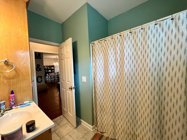 bathroom featuring tile patterned floors, vanity, and a shower with shower curtain