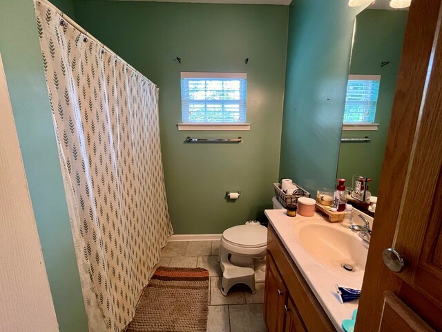 bathroom featuring tile patterned flooring, vanity, and toilet