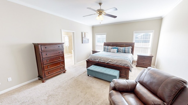 bedroom featuring ensuite bathroom, multiple windows, ornamental molding, ceiling fan, and light carpet