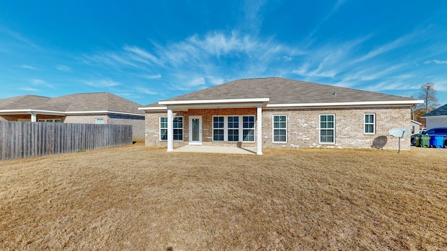 back of property featuring a yard and a patio area