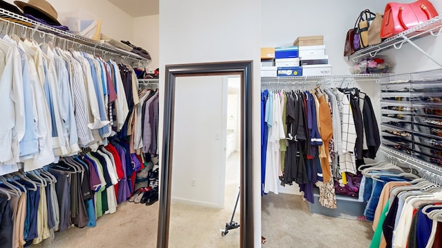 walk in closet featuring light colored carpet