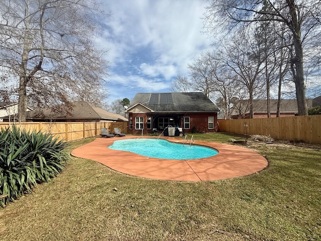 view of pool with a fenced in pool, a fenced backyard, and a lawn