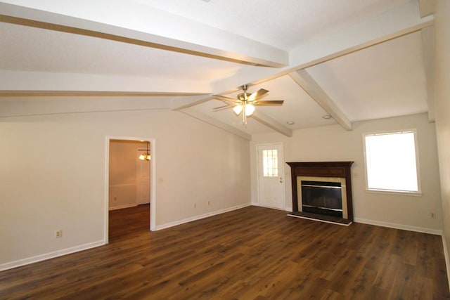 unfurnished living room featuring plenty of natural light, lofted ceiling with beams, and dark wood-type flooring