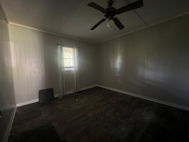 unfurnished room with ceiling fan and dark wood-type flooring