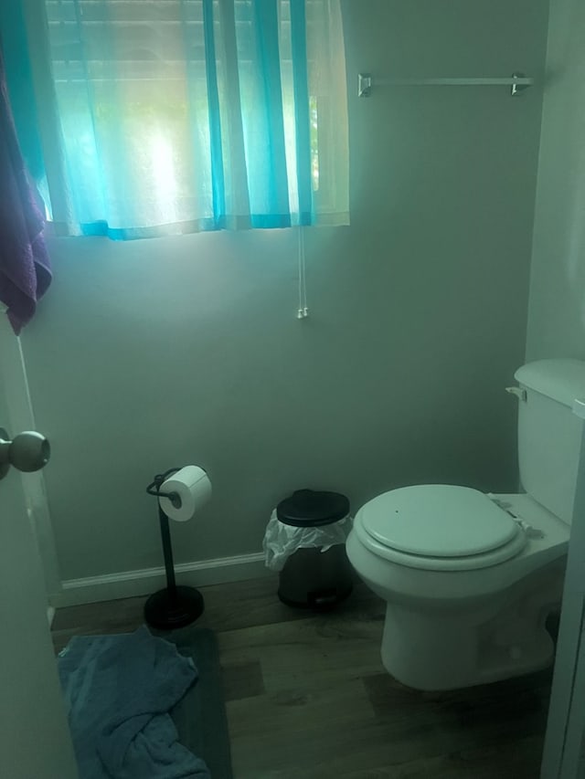 bathroom with toilet and wood-type flooring