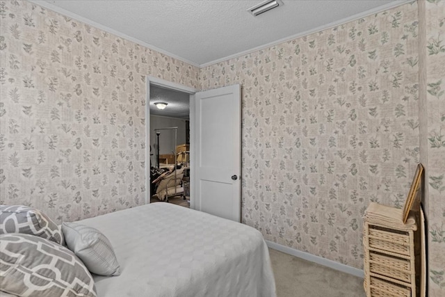 carpeted bedroom with a textured ceiling and ornamental molding