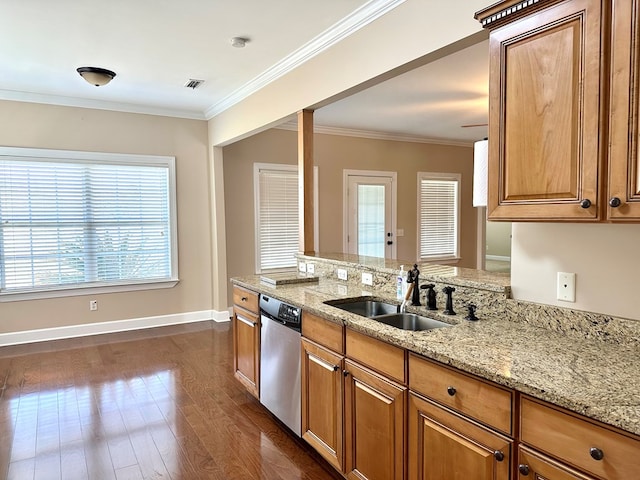 kitchen featuring ornamental molding, dishwasher, brown cabinets, and a sink