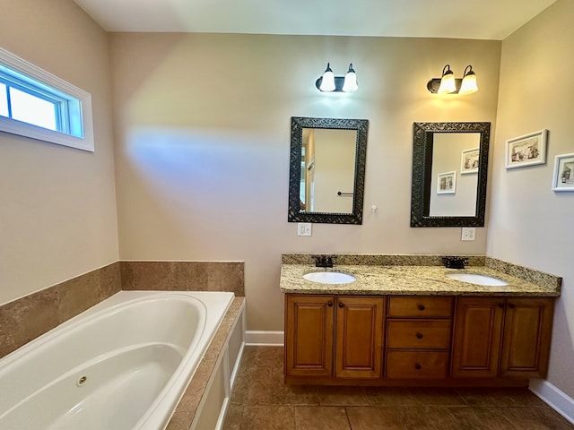 bathroom with double vanity, a bath, baseboards, and a sink