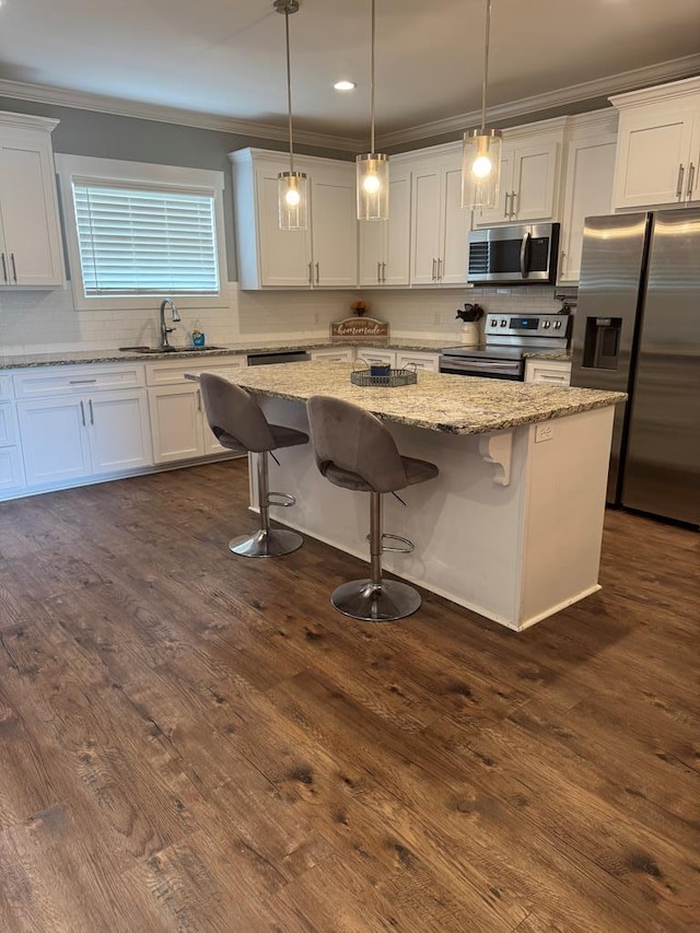 1180 Sandbed Rd, Newton, AL 36352 - kitchen with appliances with stainless steel finishes, a sink, ornamental molding, tasteful backsplash, and white cabinets