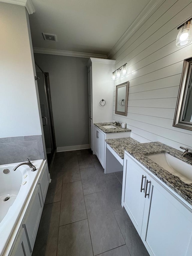 1180 Sandbed Rd, Newton, AL 36352 - full bathroom featuring two vanities, ornamental molding, tile patterned floors, a garden tub, and a shower stall