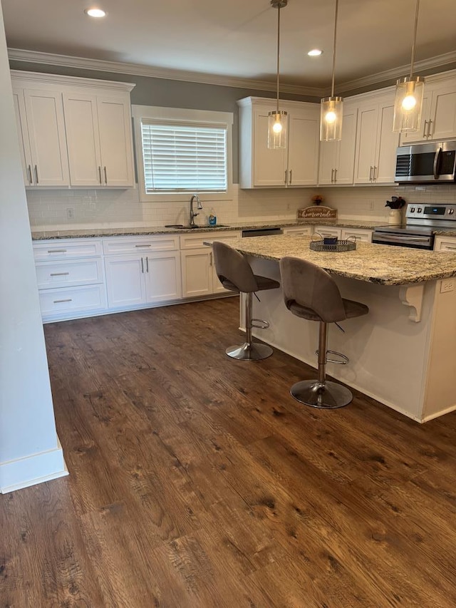 1180 Sandbed Rd, Newton, AL 36352 - kitchen with appliances with stainless steel finishes, a sink, ornamental molding, white cabinets, and tasteful backsplash