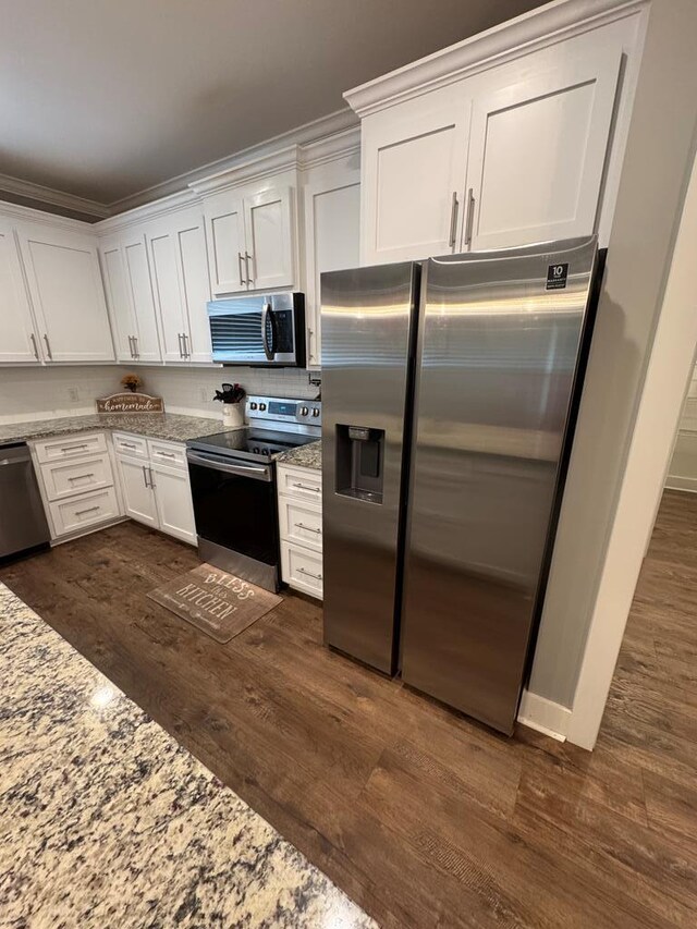 1180 Sandbed Rd, Newton, AL 36352 - kitchen with appliances with stainless steel finishes, white cabinetry, dark wood-type flooring, and crown molding