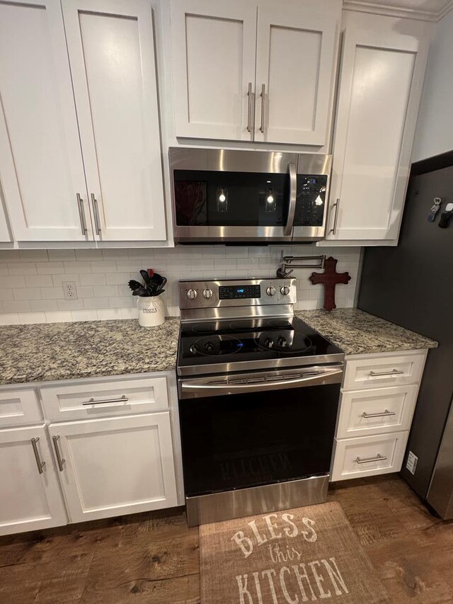 1180 Sandbed Rd, Newton, AL 36352 - kitchen featuring stainless steel appliances, white cabinetry, and backsplash