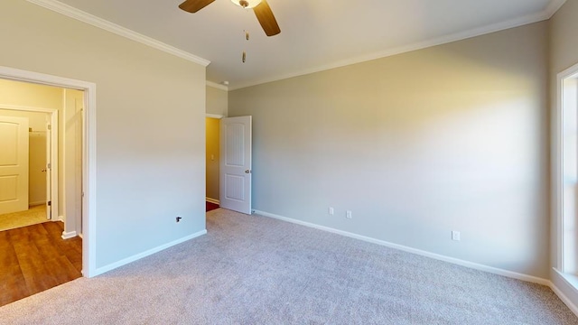 unfurnished bedroom with light colored carpet, ceiling fan, and ornamental molding