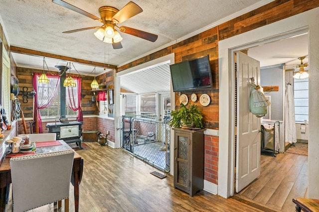 kitchen featuring visible vents, a textured ceiling, wood finished floors, and ceiling fan