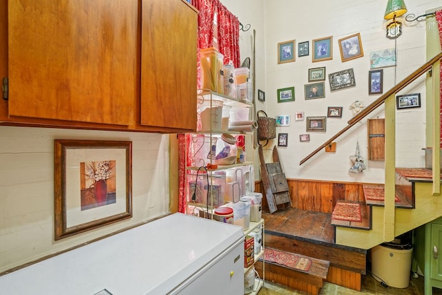 laundry room with wooden walls