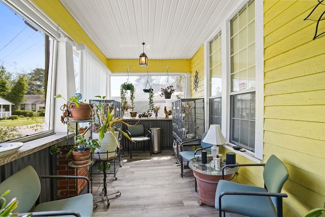 sunroom with wood ceiling, wooden walls, and wood finished floors