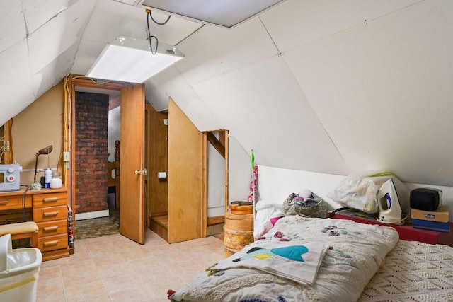 bedroom with lofted ceiling and tile patterned floors