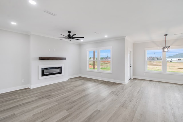 unfurnished living room with ornamental molding, ceiling fan, and light wood-type flooring