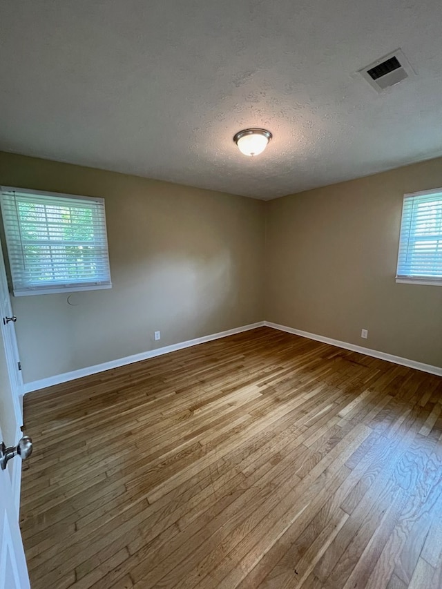 1103 Sassar St, Dothan, AL 36301 - unfurnished room with wood finished floors, baseboards, and a textured ceiling