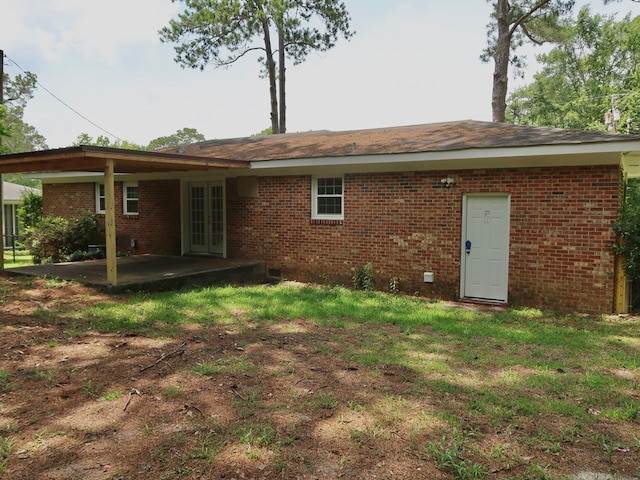 1103 Sassar St, Dothan, AL 36301 - back of house featuring french doors, a patio area, brick siding, and a lawn