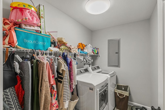 washroom featuring electric panel, laundry area, and separate washer and dryer