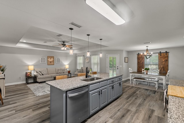 kitchen with a sink, stainless steel dishwasher, dark wood-style flooring, visible vents, and gray cabinetry