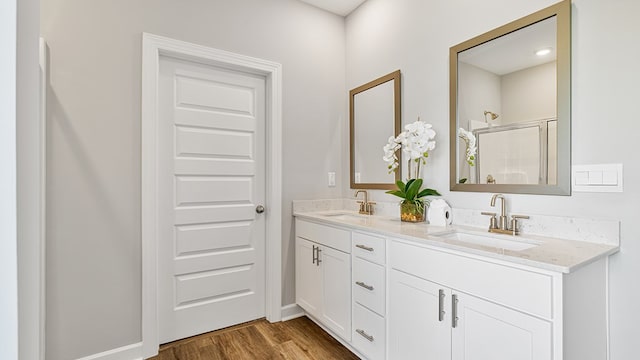 bathroom featuring wood-type flooring, vanity, and walk in shower