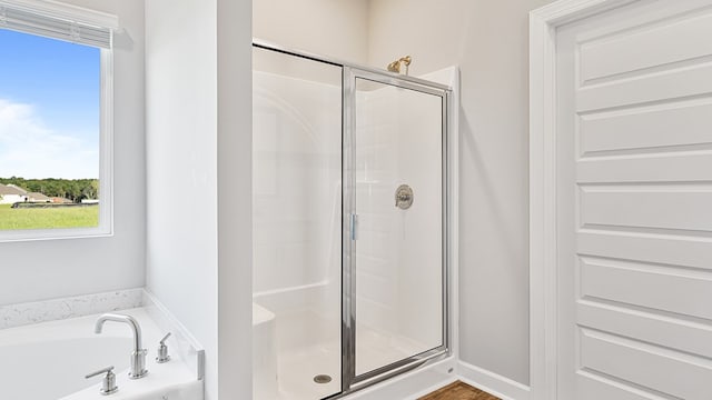 bathroom featuring separate shower and tub