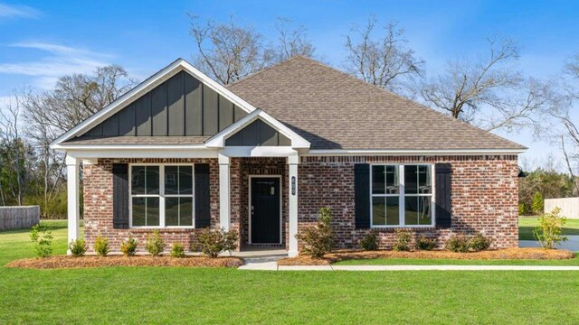 600 Golden Oaks Cir, Rehobeth, AL 36301 - view of front of home featuring brick siding, a shingled roof, board and batten siding, and a front yard